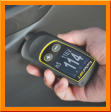 Defelkso PosiTest DFT Digital Coating Thickness Gauge measuring paint thickness on a car.